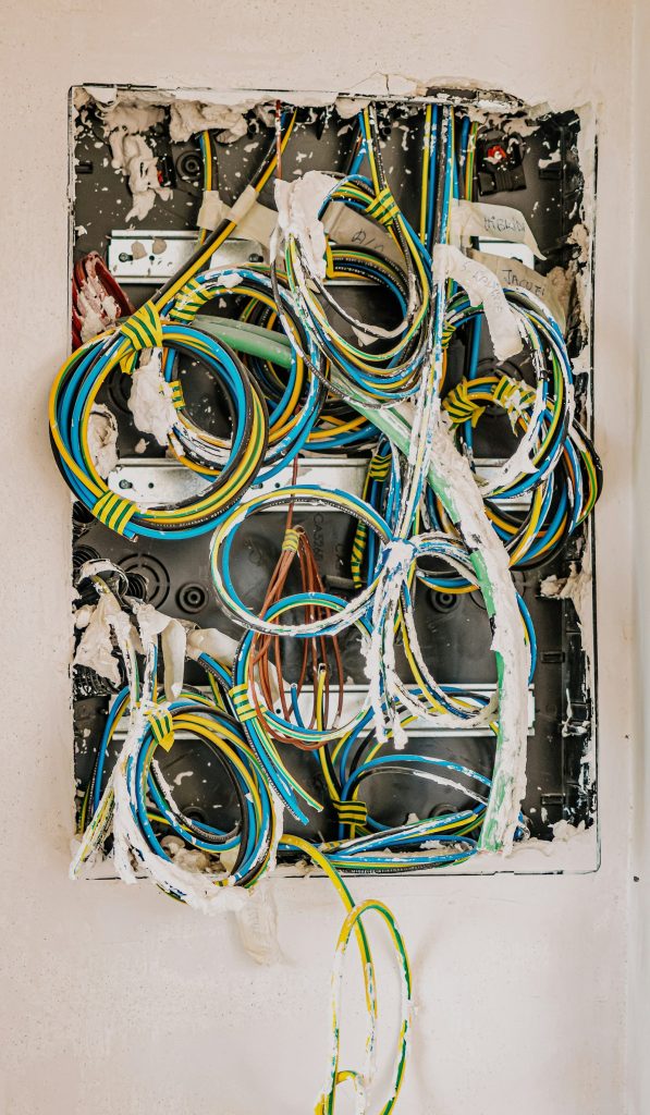 Bundle of colour-coded electrical cables neatly routed inside an enclosure