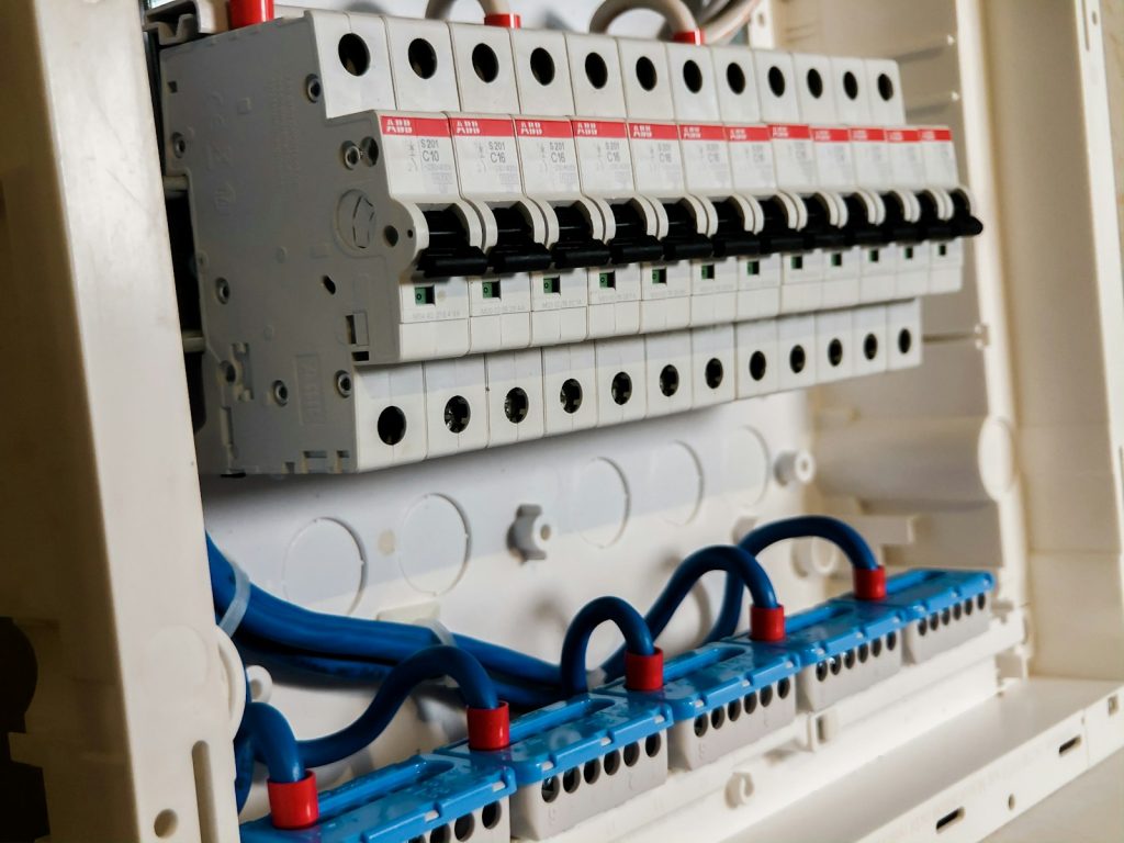 Row of modern white miniature circuit breakers in a new consumer unit