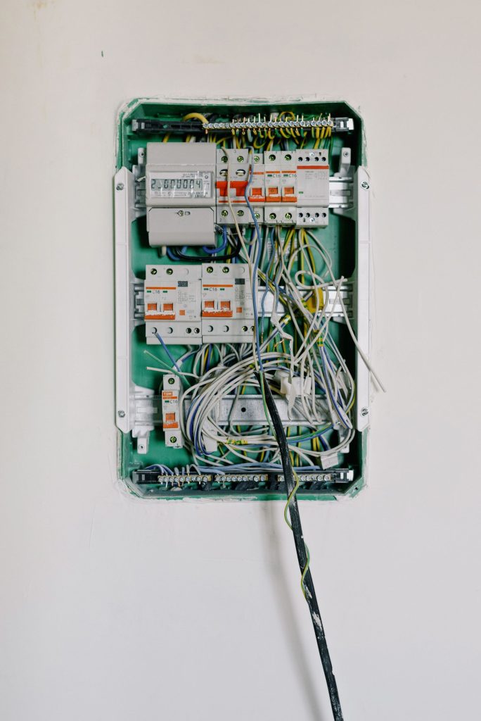 Wall-mounted switchboard with circuit breakers and wiring